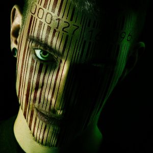 Close up of mans face with a full length barcode scanned on to it.