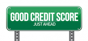 Green road sign with Good Credit Score Just Ahead written on it with large white letters.